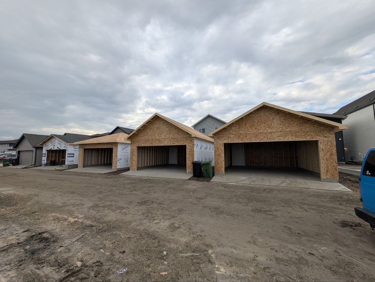 Three detached garages framed and sheathed